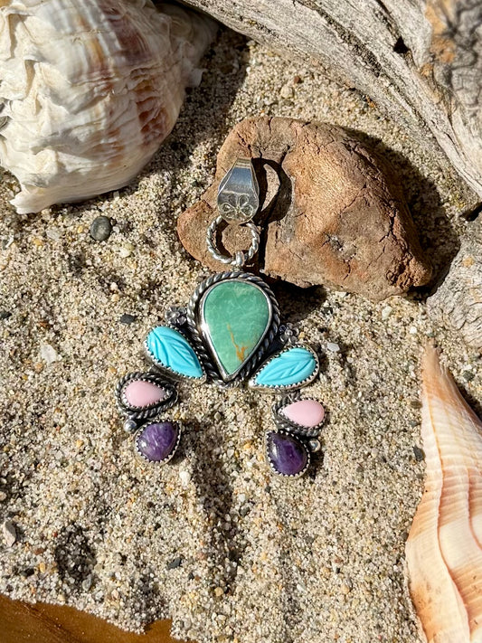 Close-up of turquoise stone set in sterling silver naja pendant showing detail