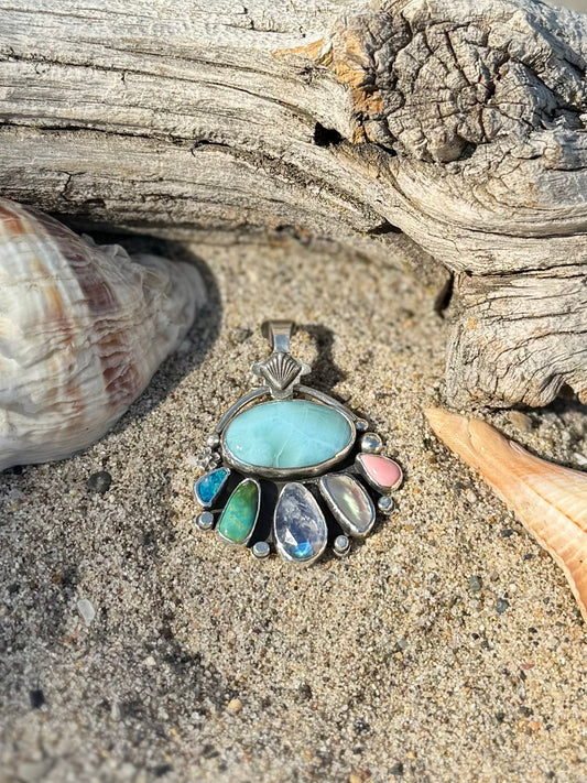 Close-up of Larimar stone and opal showing blue color and rainbow flash