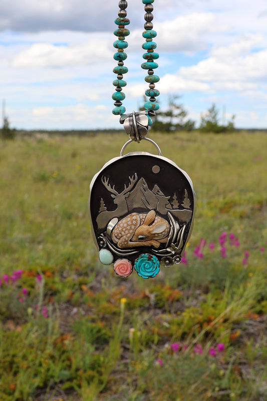 Handmade sterling silver story pendant featuring a Spotted Fawn Jasper baby deer by Laura Mears with parents watching over it in a mountain scene