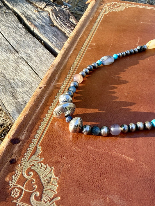 Handmade sterling silver pearls stamped with bear pine trees and antlers on Montana Agate Sapphire and Kingman turquoise necklace