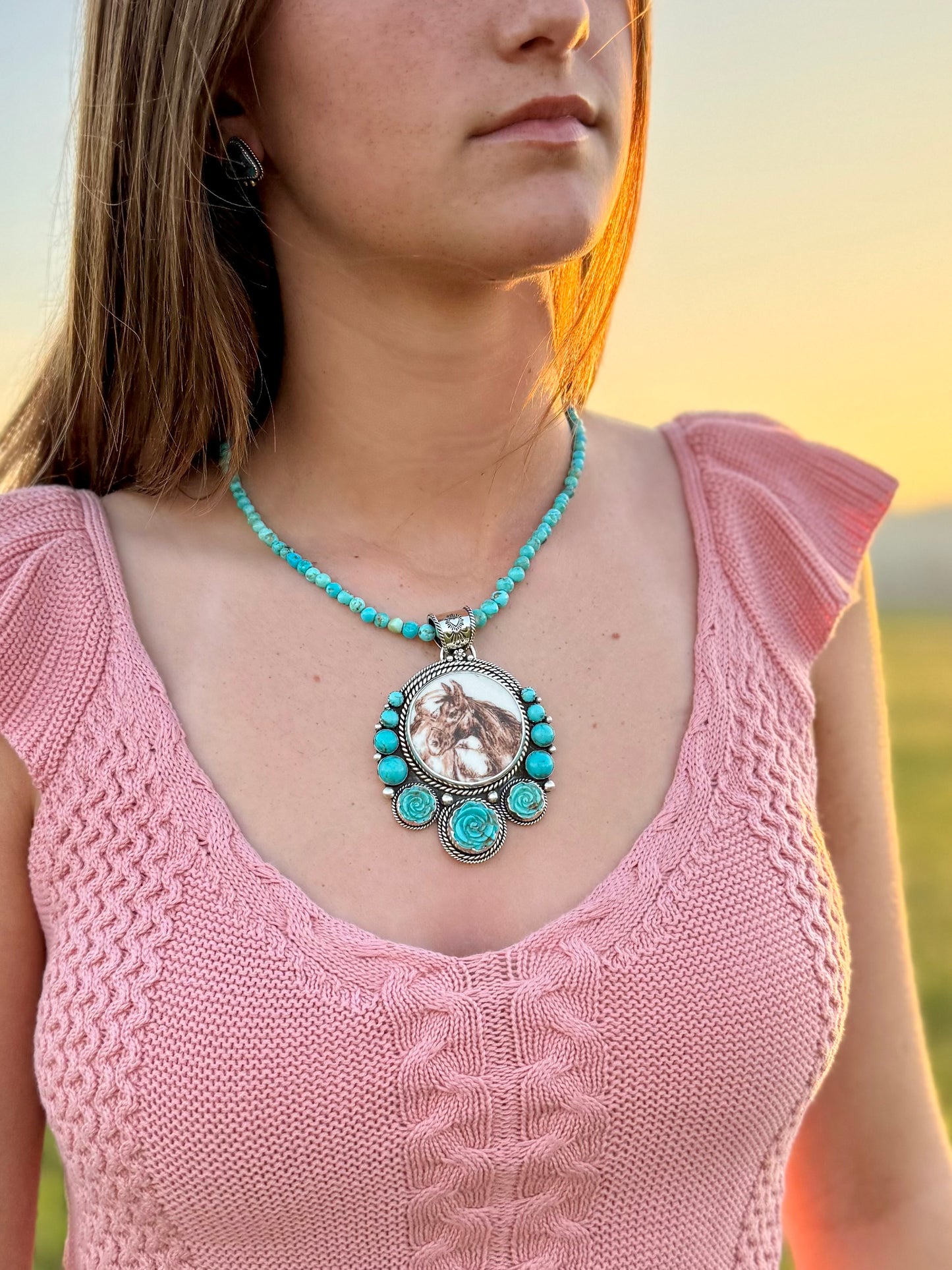 Woman wearing Horse turquoise pendant in sterling silver with natural blue green stone
