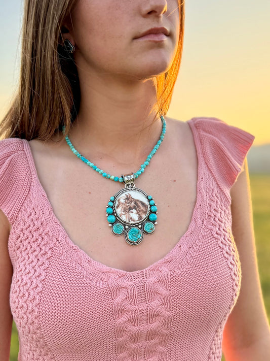 Woman wearing Horse turquoise pendant in sterling silver with natural blue green stone