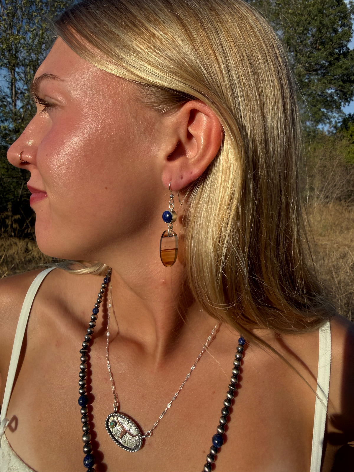 Montana Agate and Lapis Lazuli sterling silver dangle earrings worn by model outdoors in Montana by Donnalee Silver