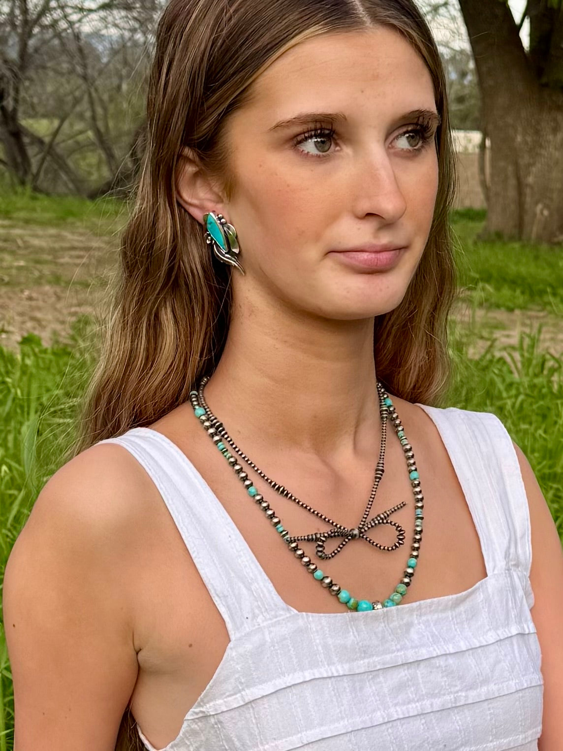 Turquoise post earrings showing size and proportions on ear