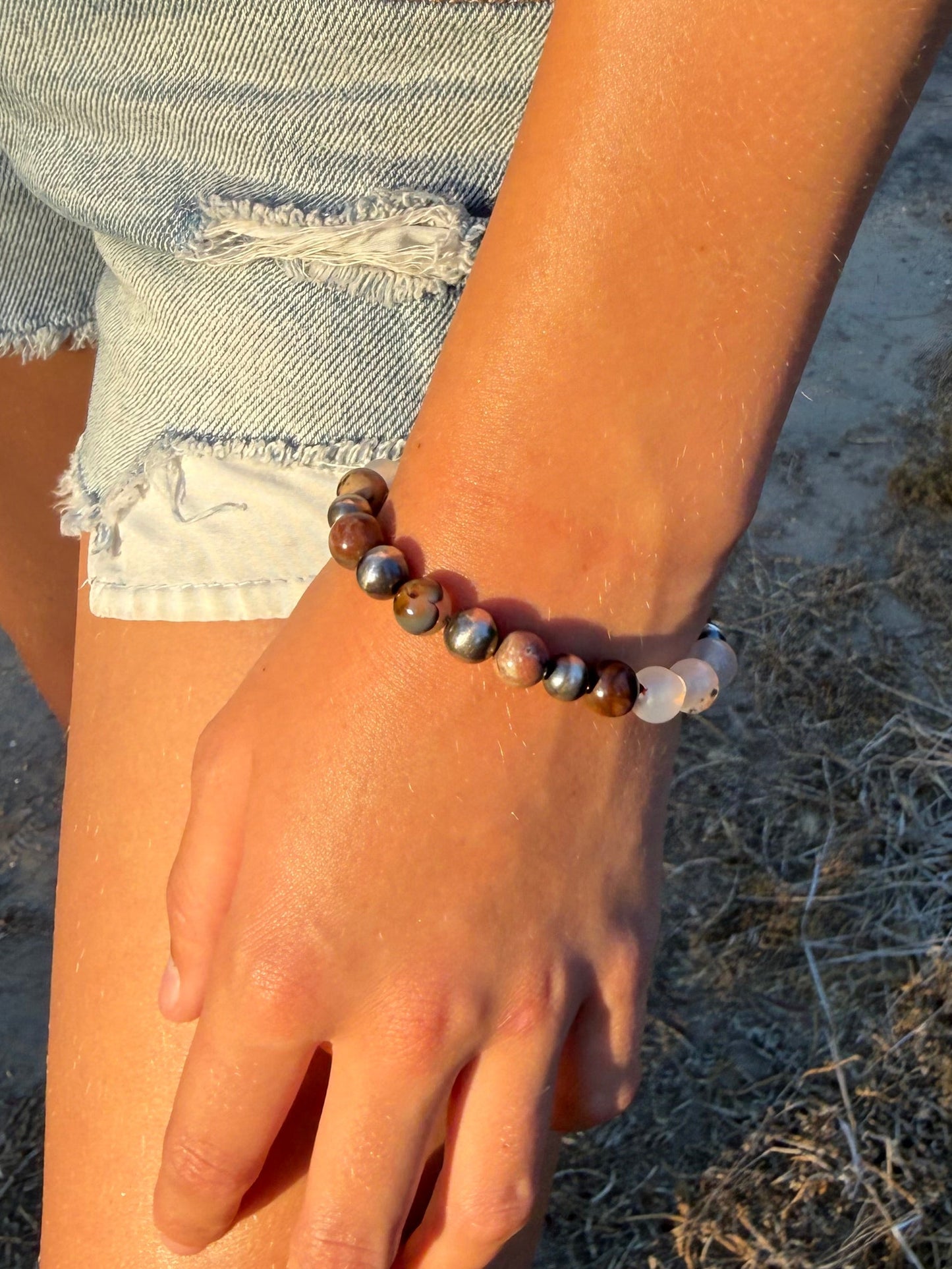 Handmade Montana agate and petrified wood sterling silver beaded bracelet shown on wrist