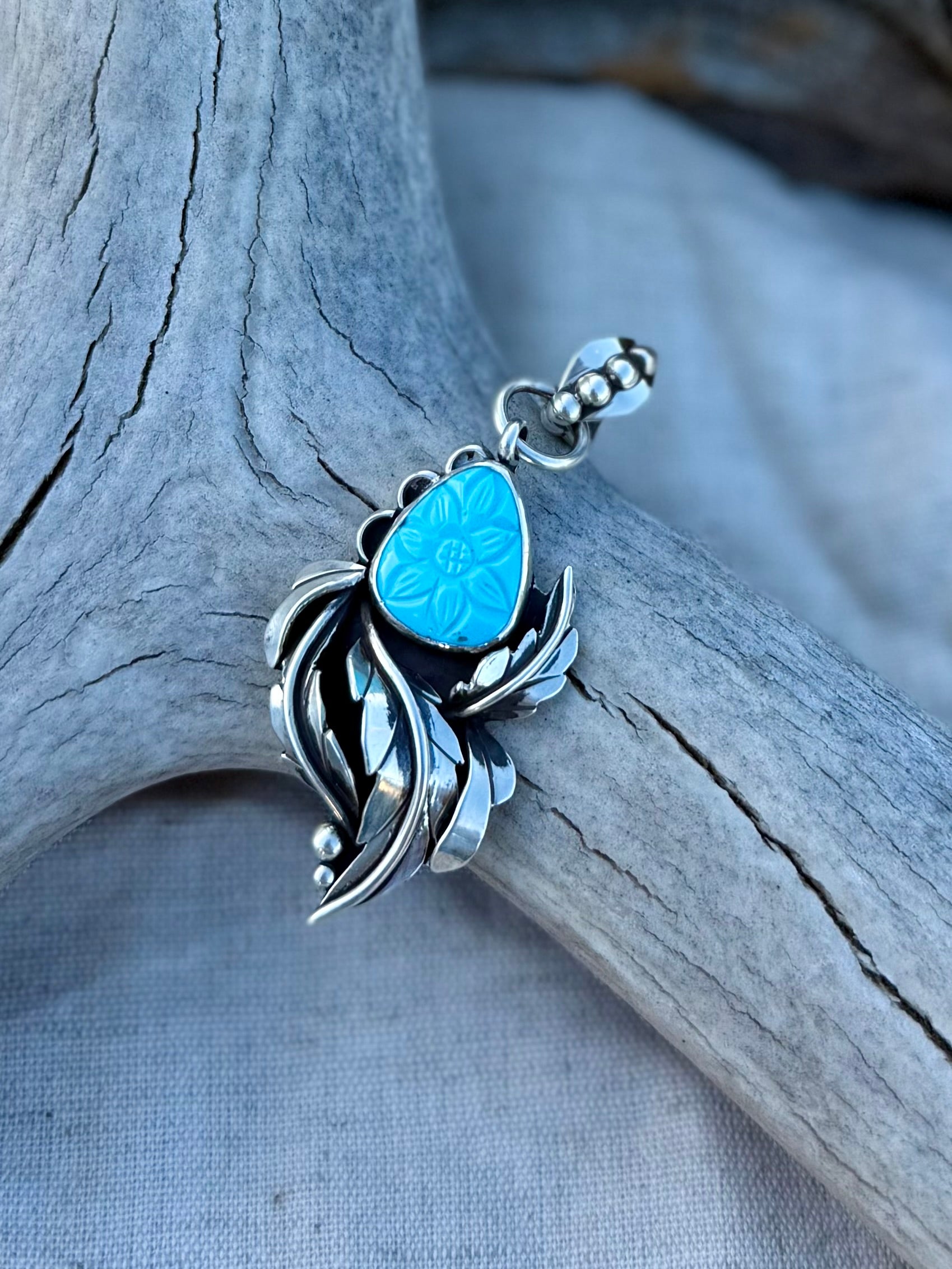Close-up of hand carved Persian turquoise showing bright blue color and natural surface