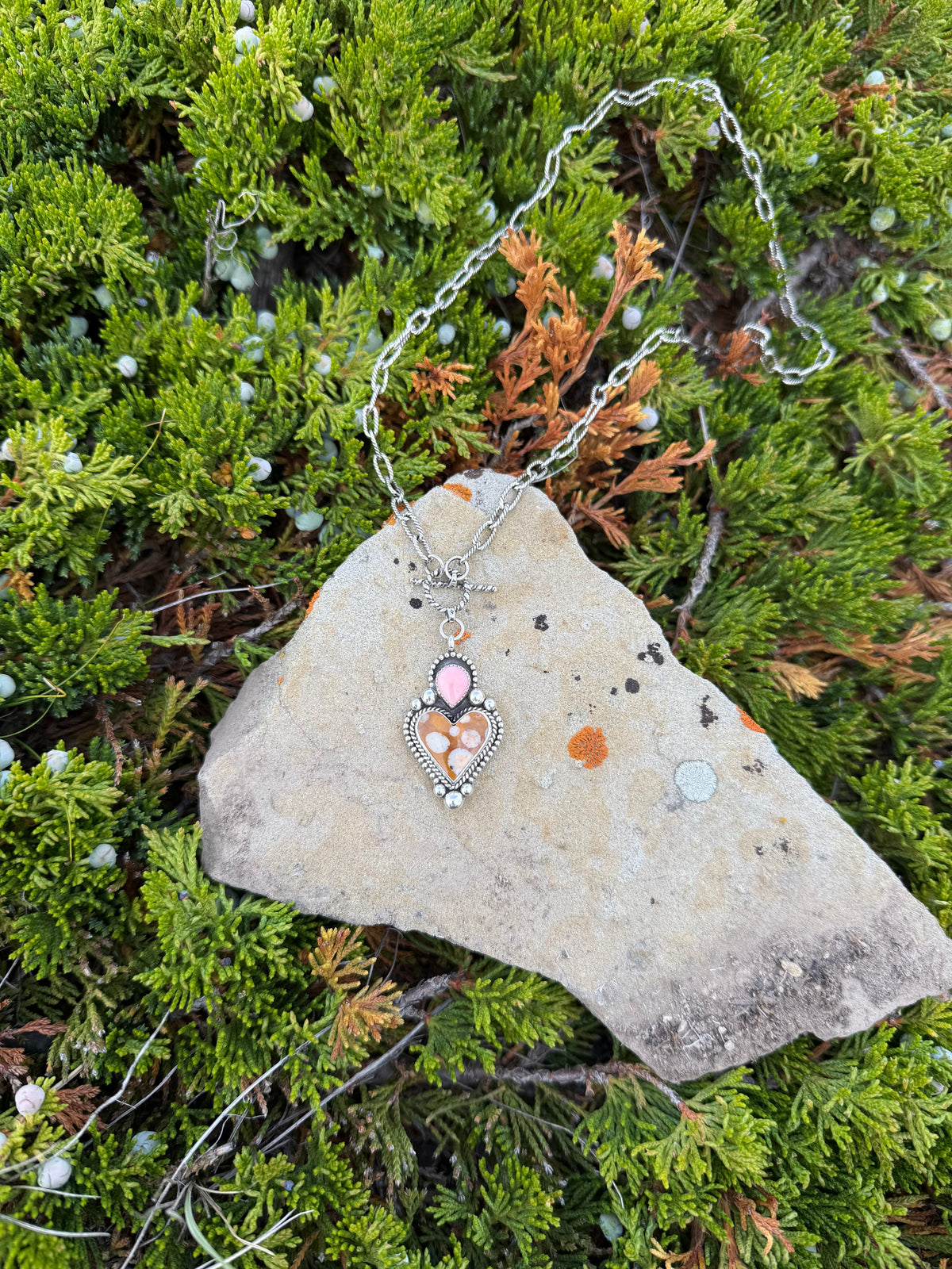 Handmade sterling silver heart necklace featuring Spotted Fawn Jasper and Pink Conch with silver bead and twisted wire details