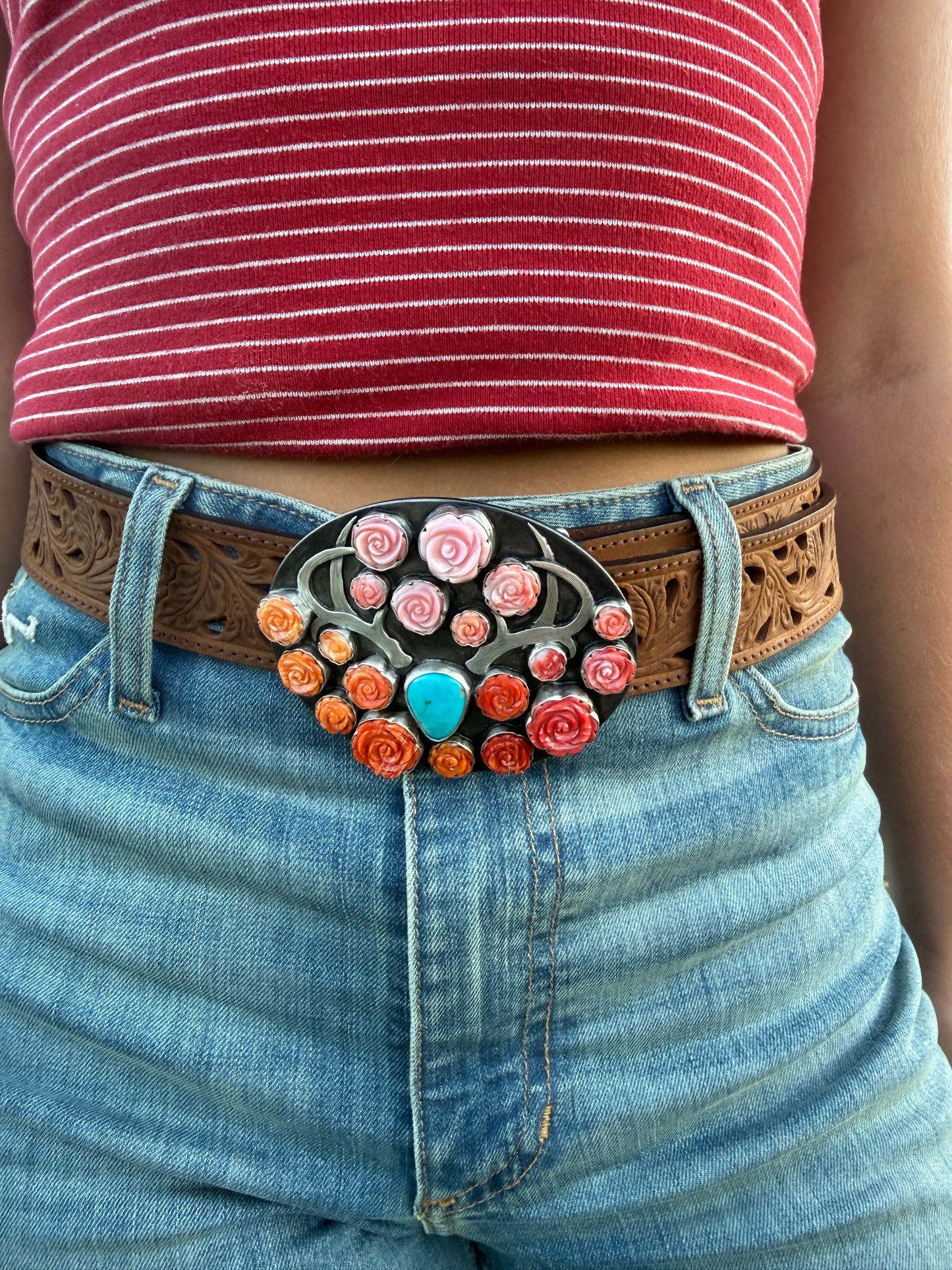 Handmade western belt buckle featuring ombré pink conch, red and orange spiny oyster roses surrounding a Royston Turquoise centerpiece with a hand-engraved sterling silver longhorn on a steel buckle base with fine silver bezels.