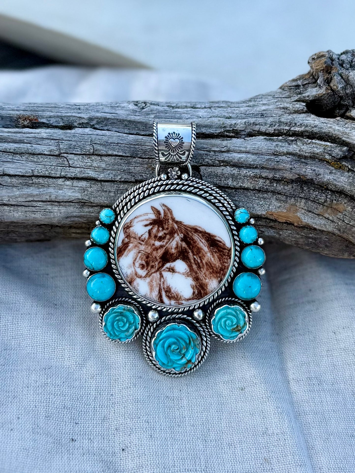 Close-up of turquoise stone and horse design showing handcrafted detail  and hand carved turquoise