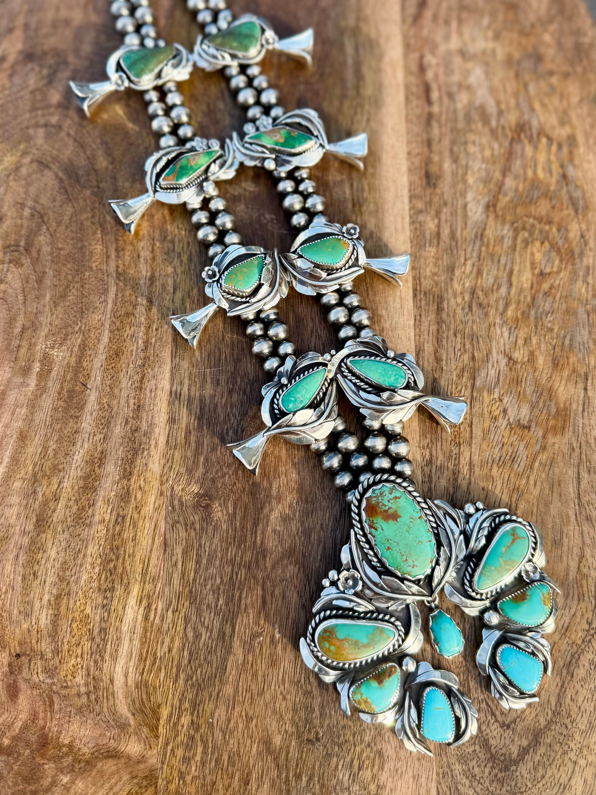 Full layout of squash blossom necklace showing complete design and stone placement