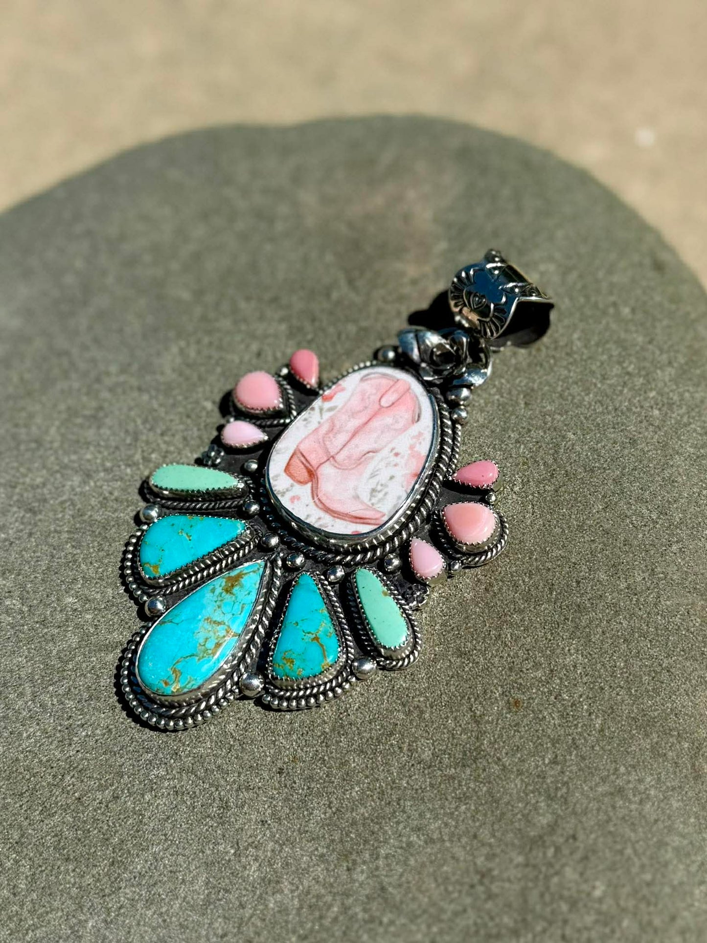 Side view of sterling silver boot pendant showing depth and craftsmanship