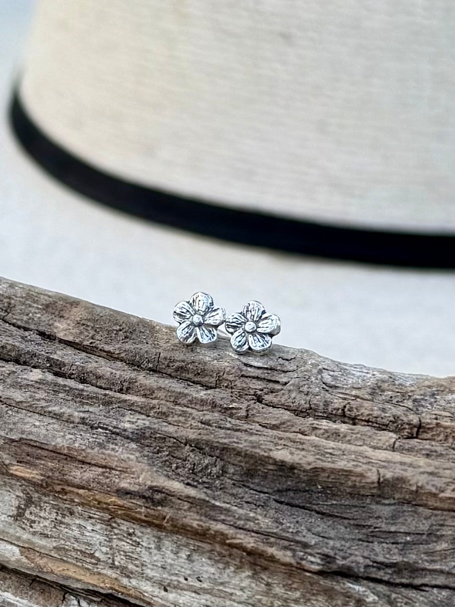 Sterling silver flower stud earrings with simple floral design and polished finish