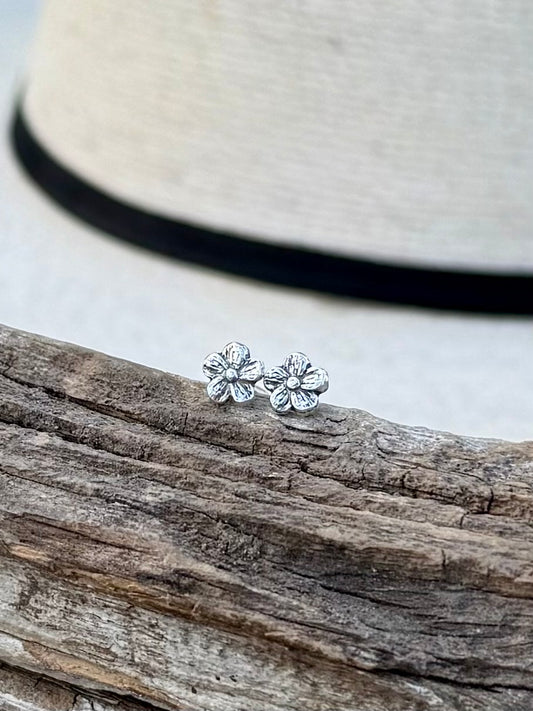 Sterling silver flower stud earrings with simple floral design and polished finish