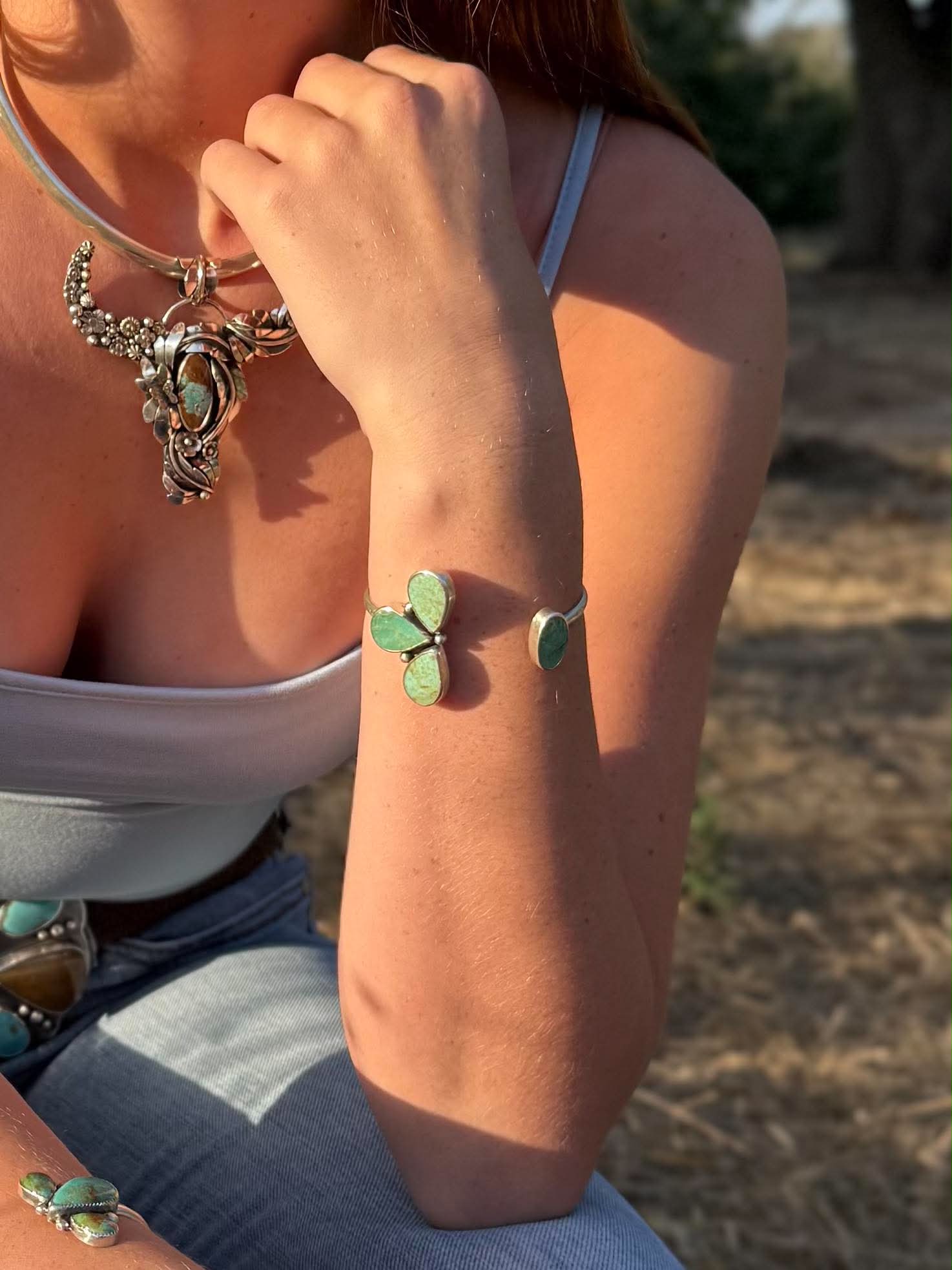 Handmade sterling silver cuff bracelet with Sonoran Gold and Chilean turquoise in asymmetrical floral pinch petal design