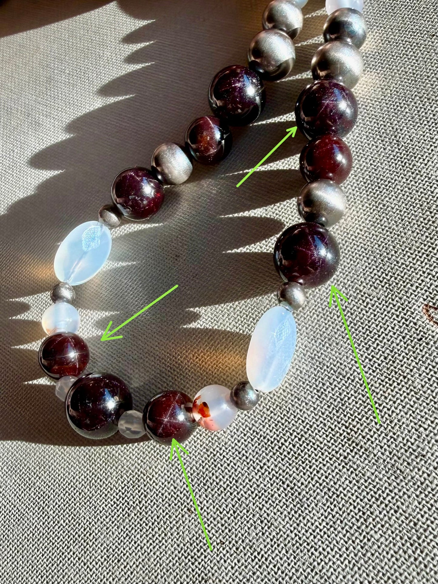 Close up of natural Montana agate star garnet and oxidized sterling silver pearl beaded necklace