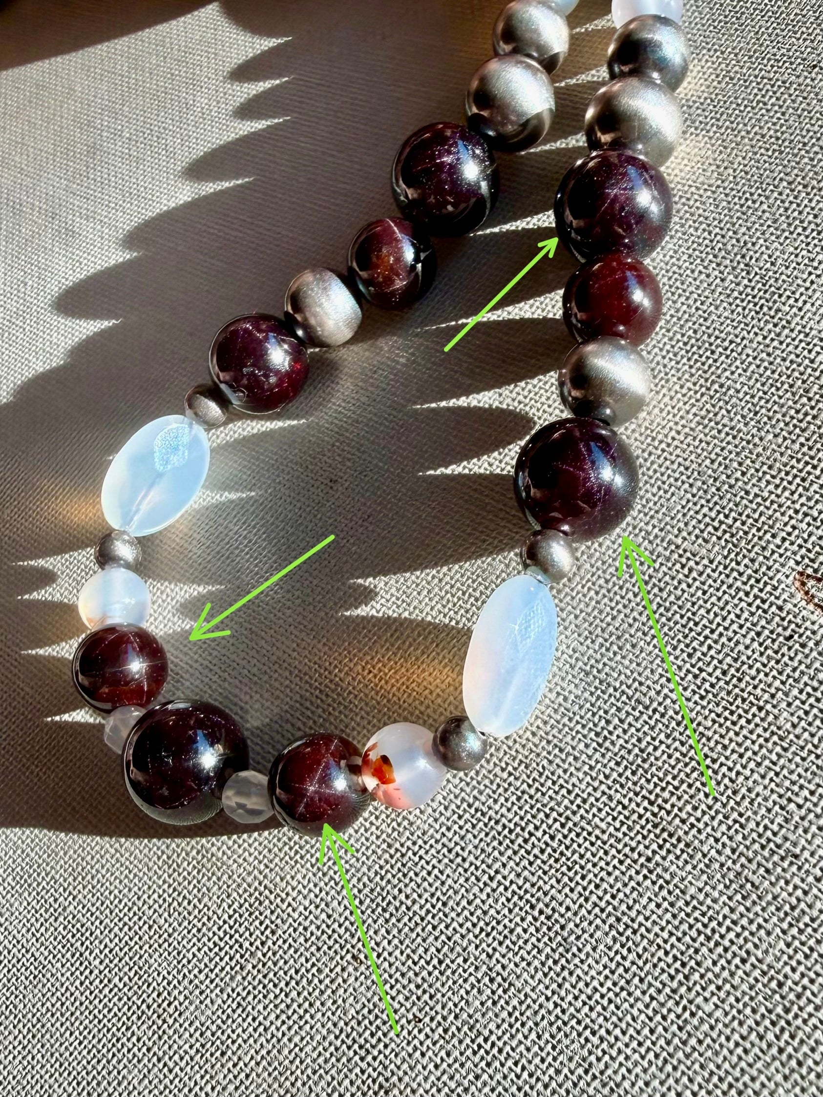 Close up of natural Montana agate star garnet and oxidized sterling silver pearl beaded necklace