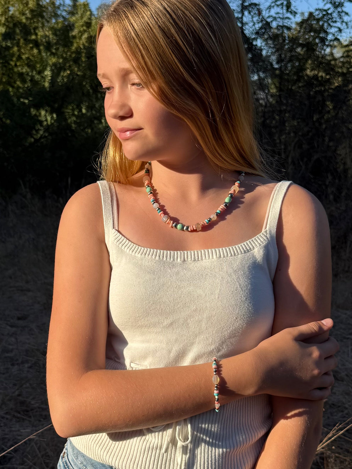 Close up of Montana Agate Kingman turquoise Variscite Pink Conch and sterling silver beads in handmade Western necklace