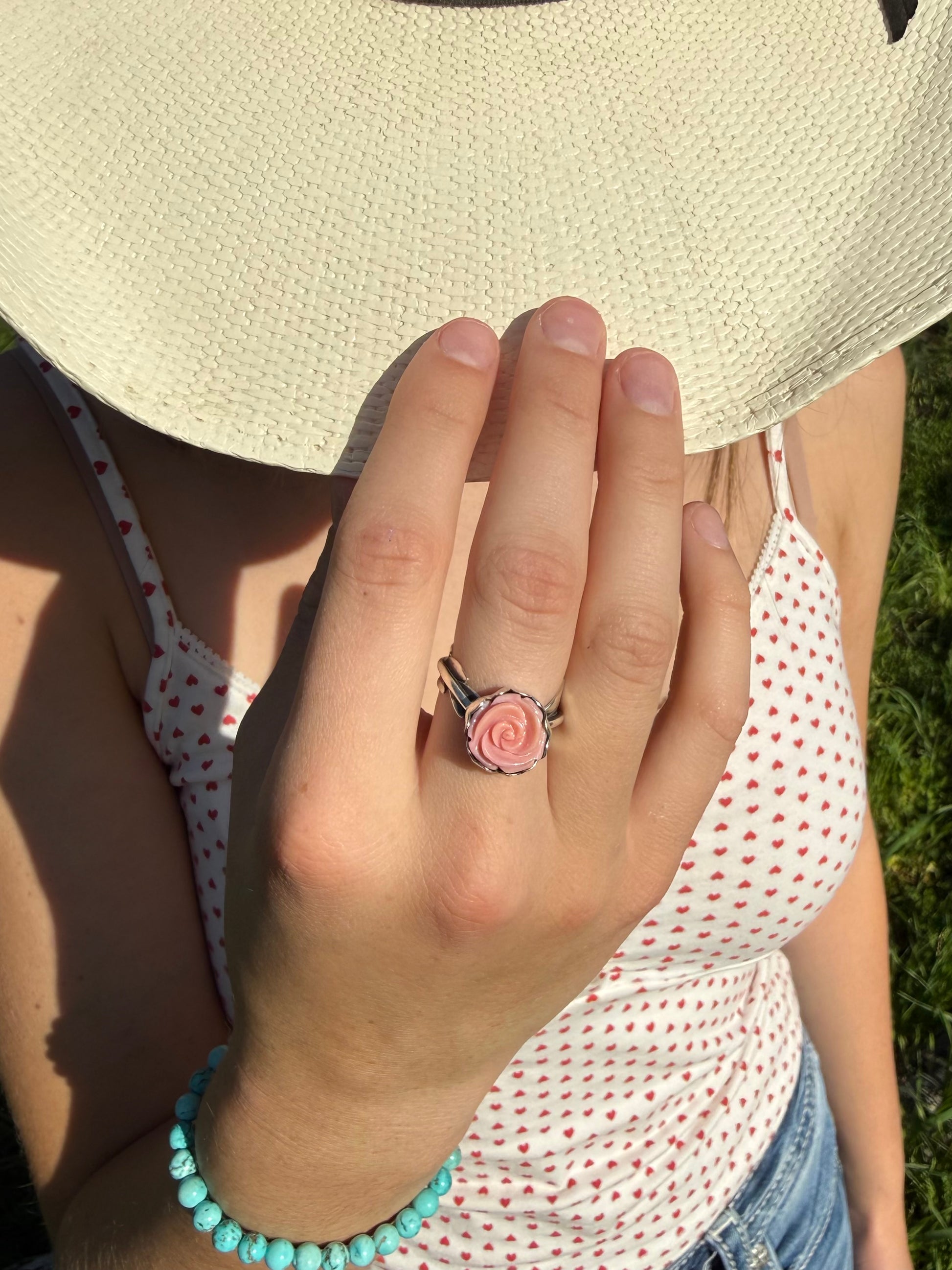Pink conch floral ring showing size and proportions on finger