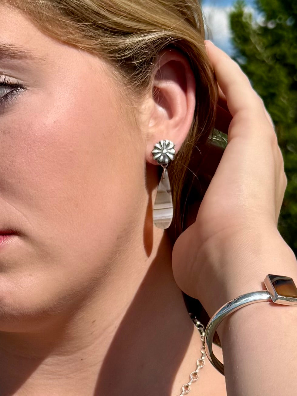 Model wearing handmade Montana Agate drop earring jackets with sterling silver Western concho studs by Donnalee Silver.