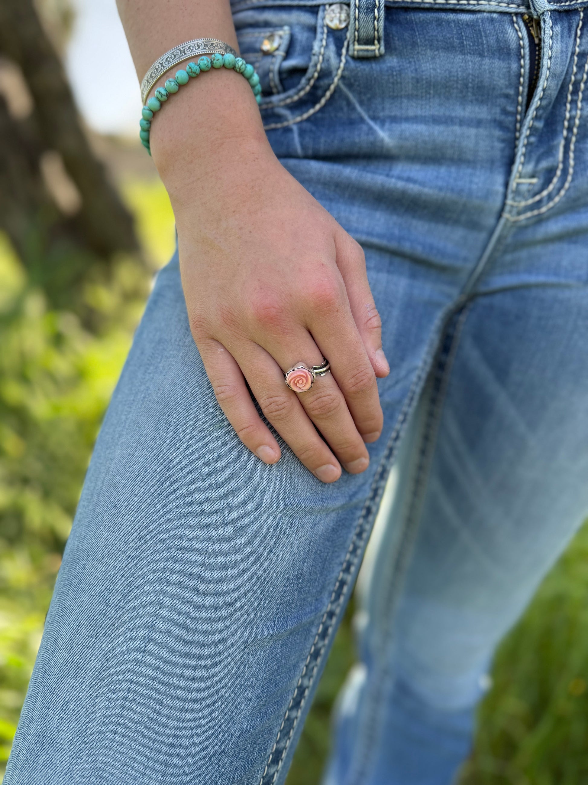 Pink conch rose ring worn on hand, feminine boho floral statement jewelry