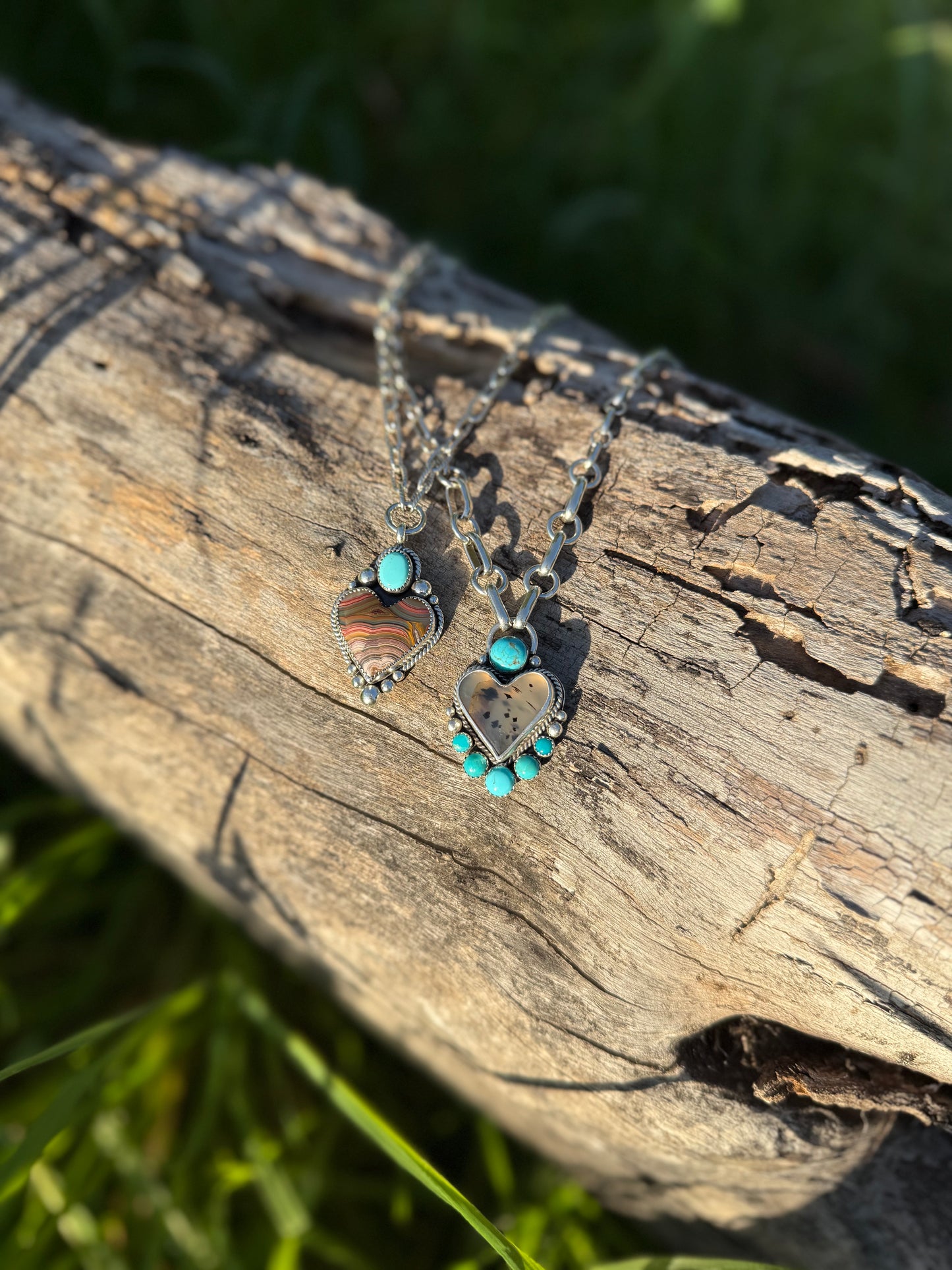 Montana agate and Kingman turquoise heart necklace in sterling silver with earthy and blue tones shown with a Laguna Lace agate heart necklace