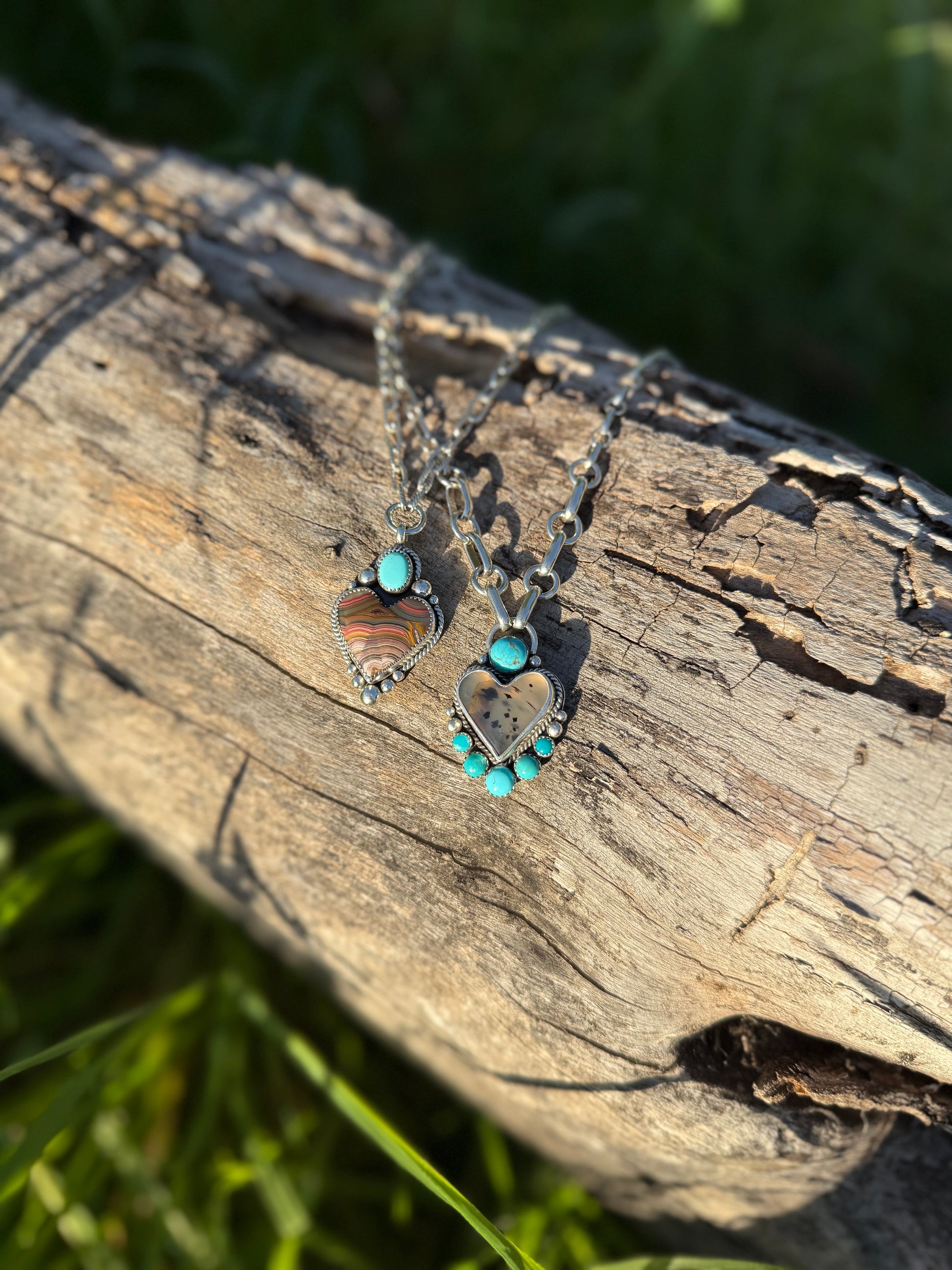 Montana agate and Kingman turquoise heart necklace in sterling silver with earthy and blue tones shown with a Laguna Lace agate heart necklace