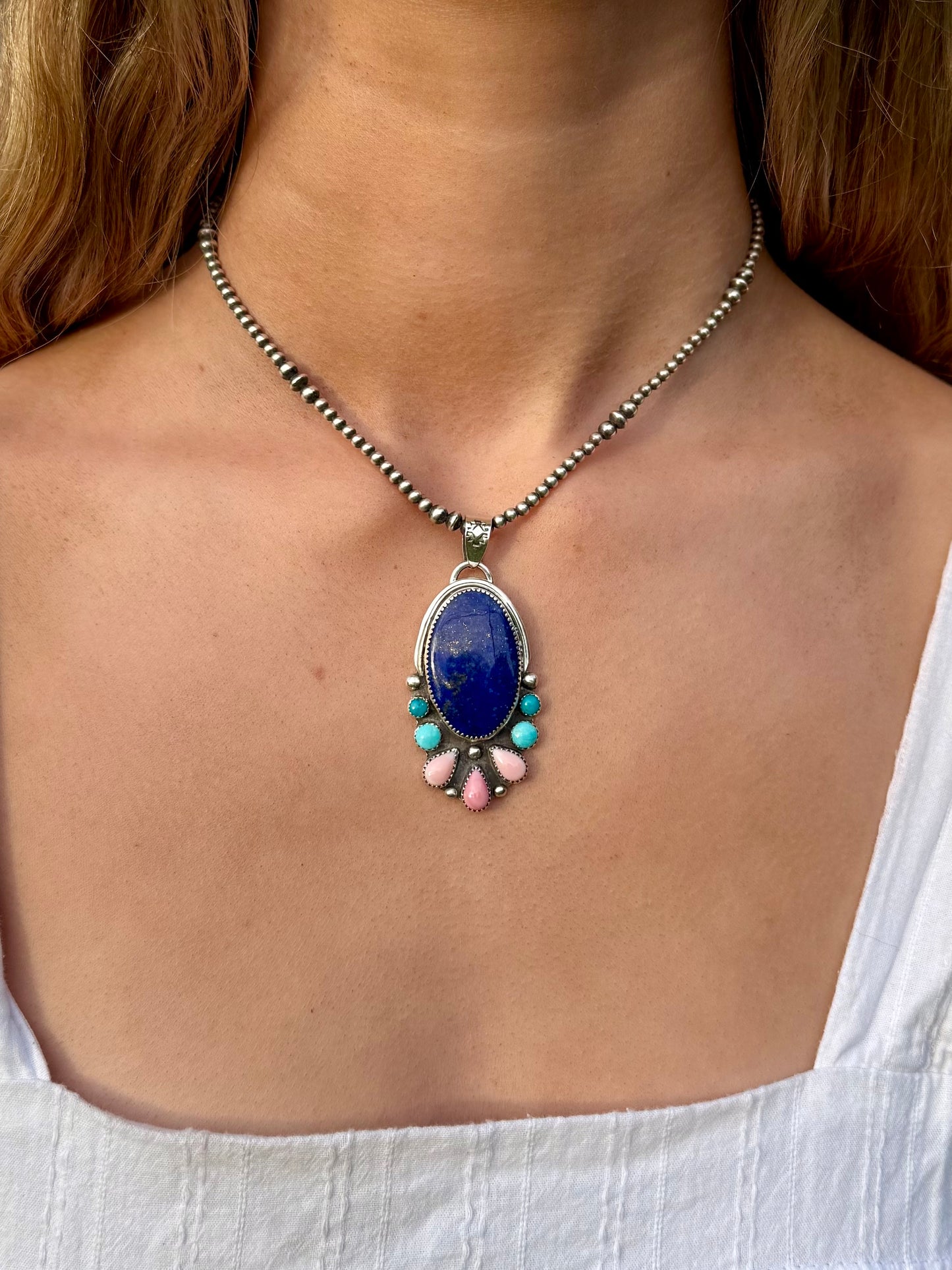 Lapis lazuli, pink conch, and Kingman turquoise pendant in sterling silver with bold blue and blush tones