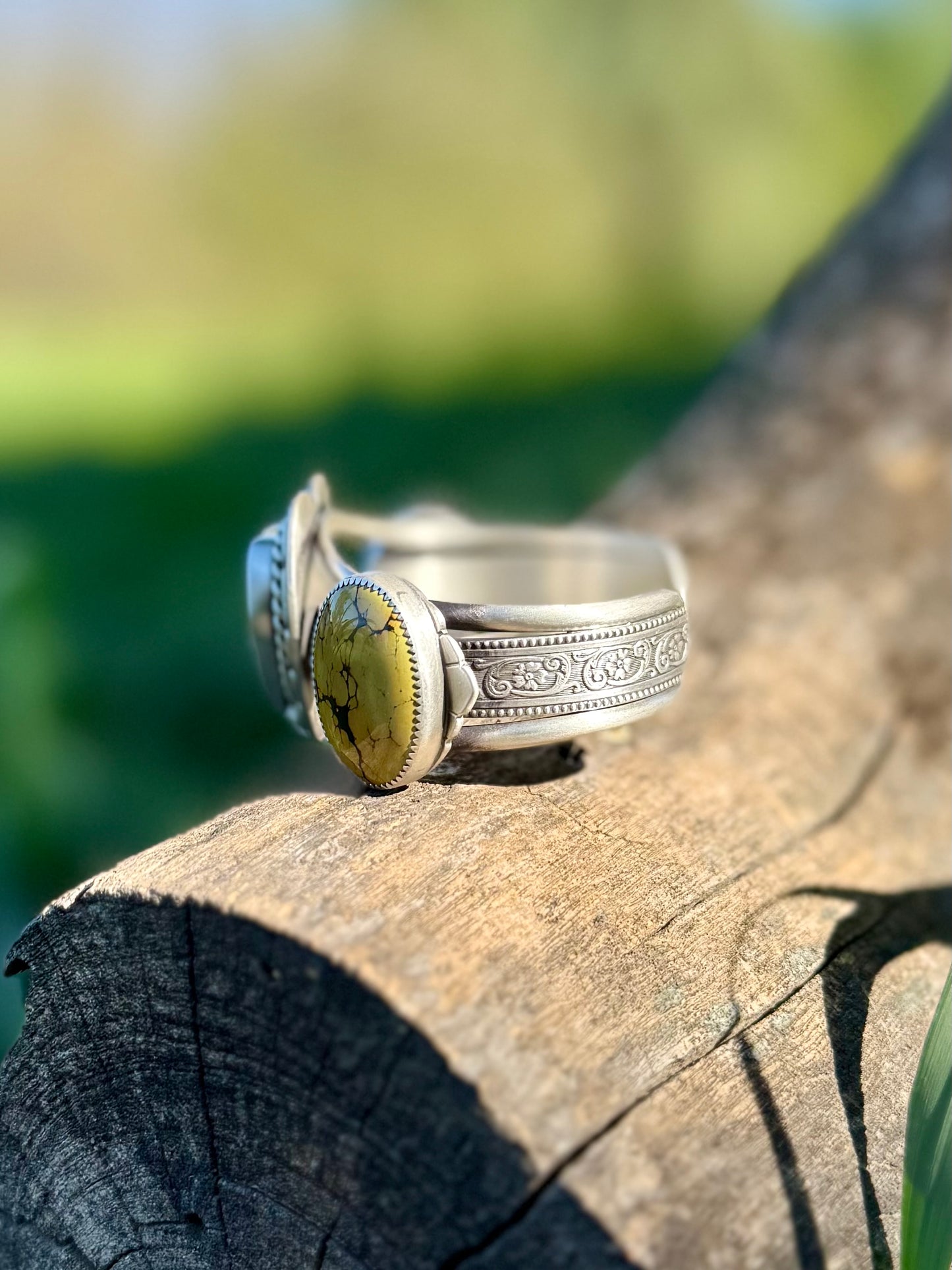 Side view of sterling silver cuff bracelet showing turquoise setting and detailed band