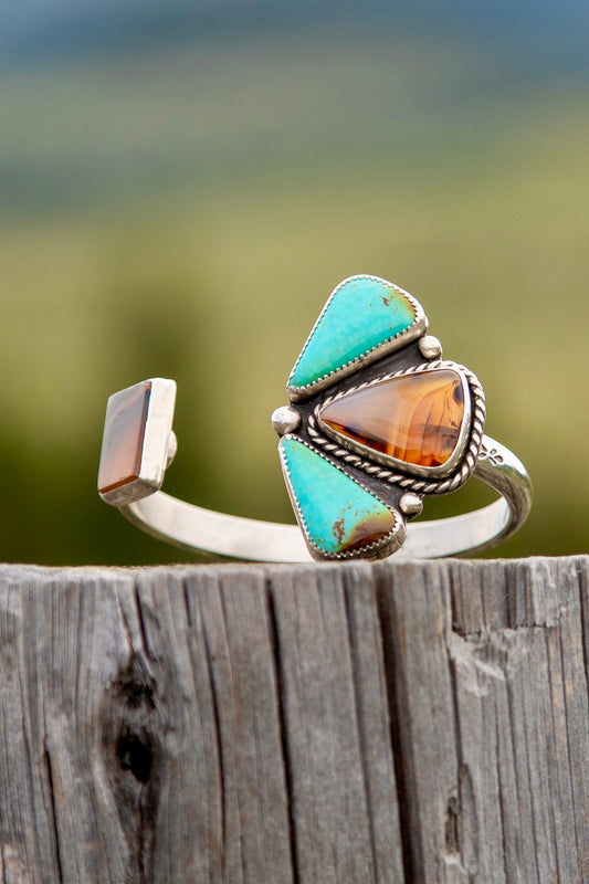 Handmade sterling silver pinch petal cuff with Montana Agate center stone and Kingman Turquoise petals