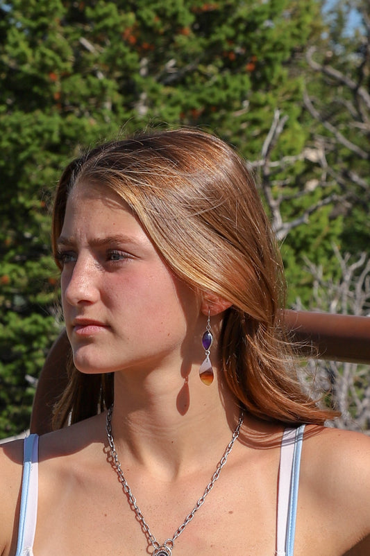 Handmade sterling silver dangle earrings featuring genuine Montana Agate and Amethyst gemstones with fishhook ear wires and a high polish finish.