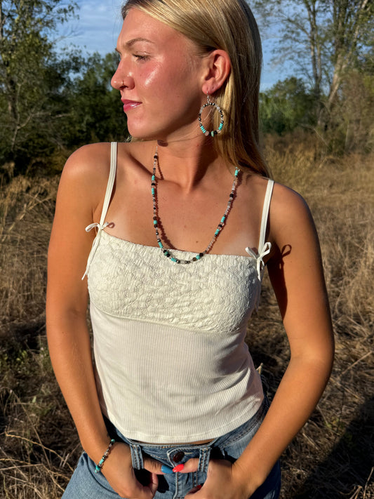 Model wearing handmade Montana Agate and Kingman turquoise gemstone jewelry set from the Montana Collection