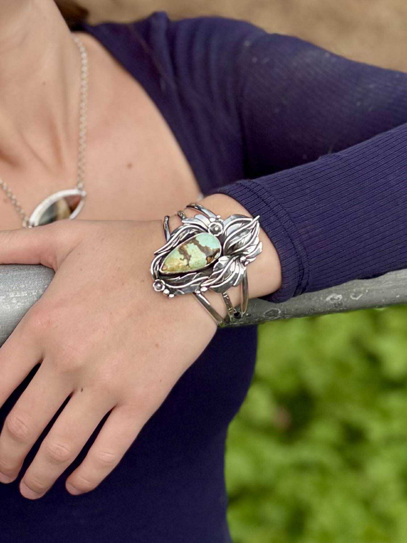 Side view of sterling silver cuff bracelet showing band and stone setting