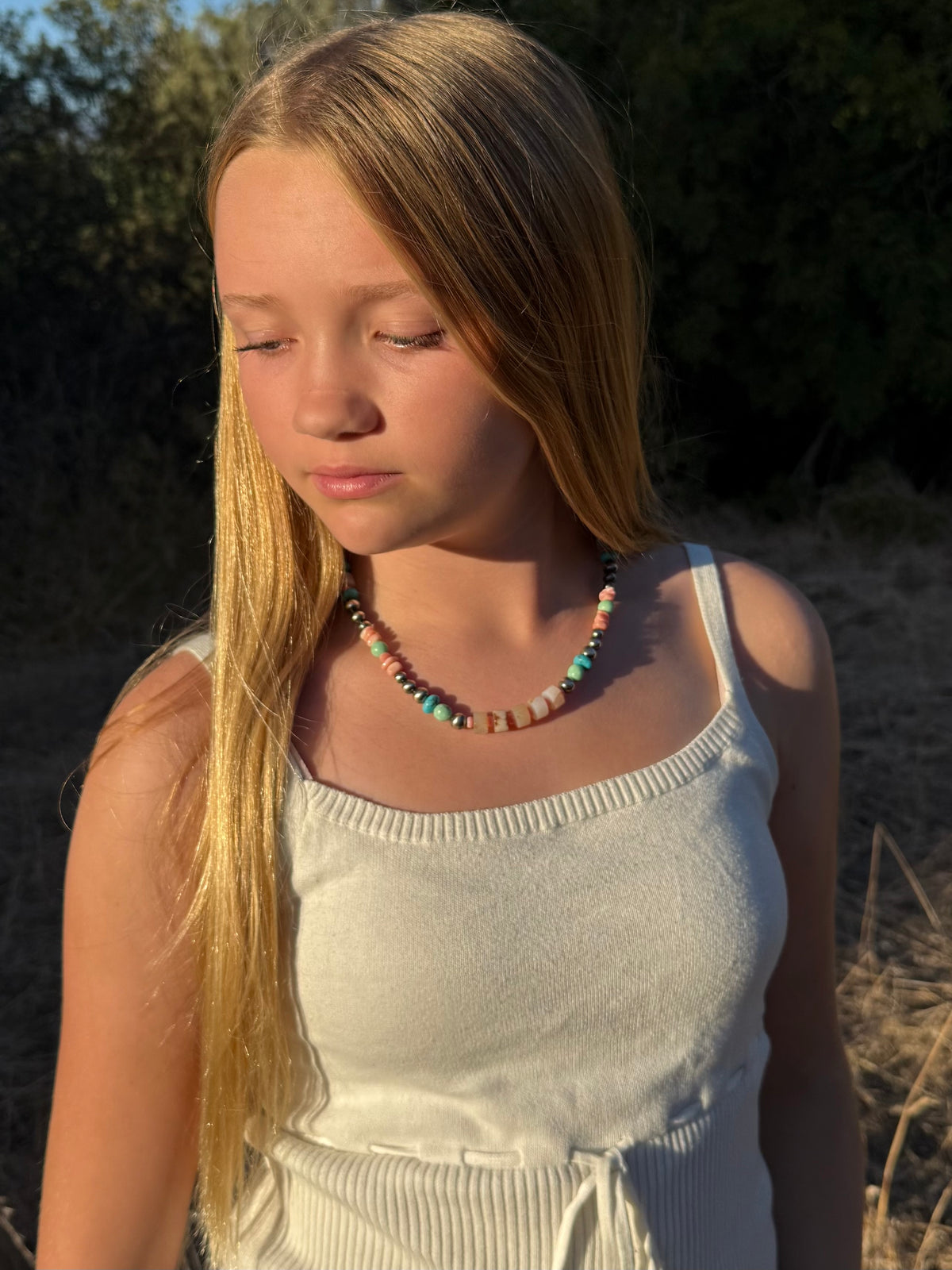 Model wearing Montana Agate and turquoise beaded necklace handmade by Donnalee Silver