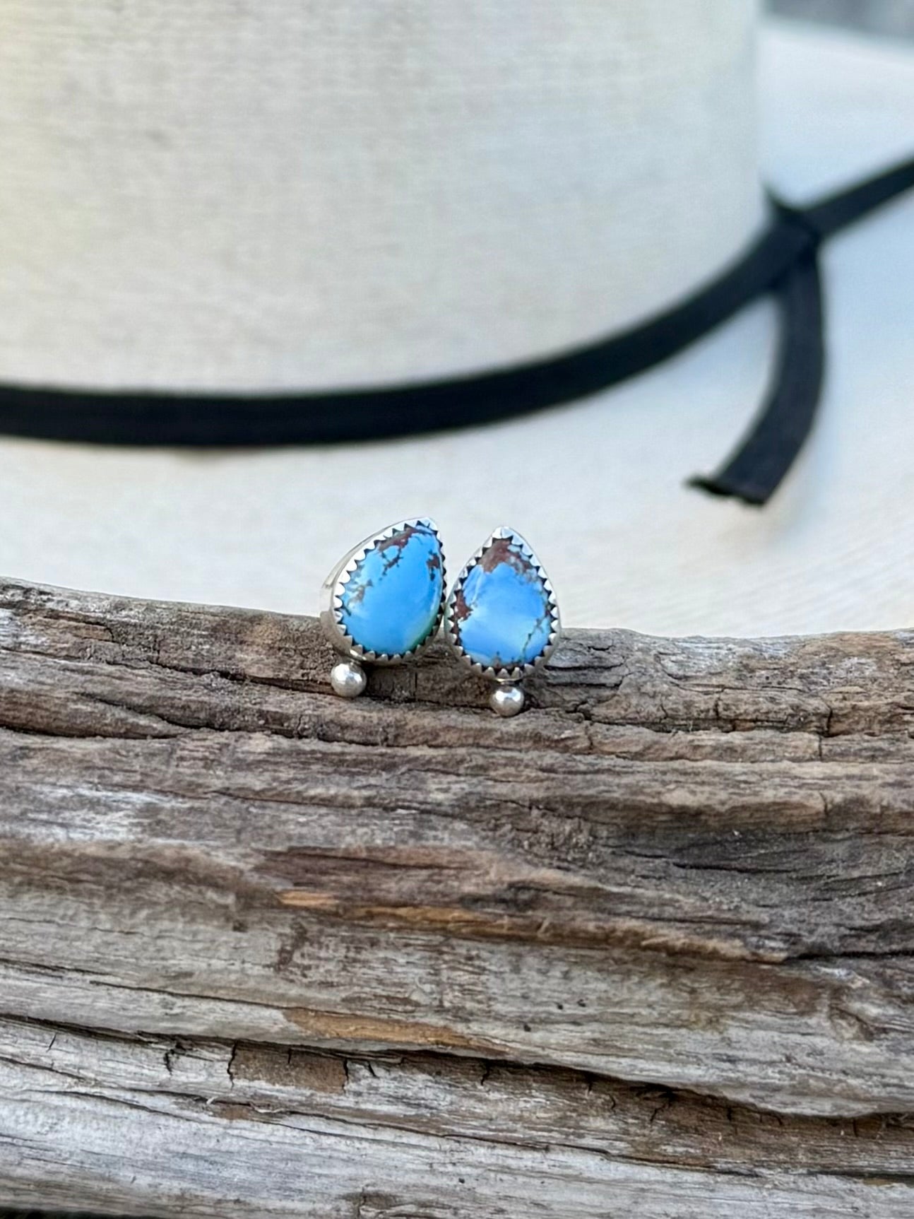 Close-up of Golden Hills turquoise teardrop studs showing light blue color and natural matrix