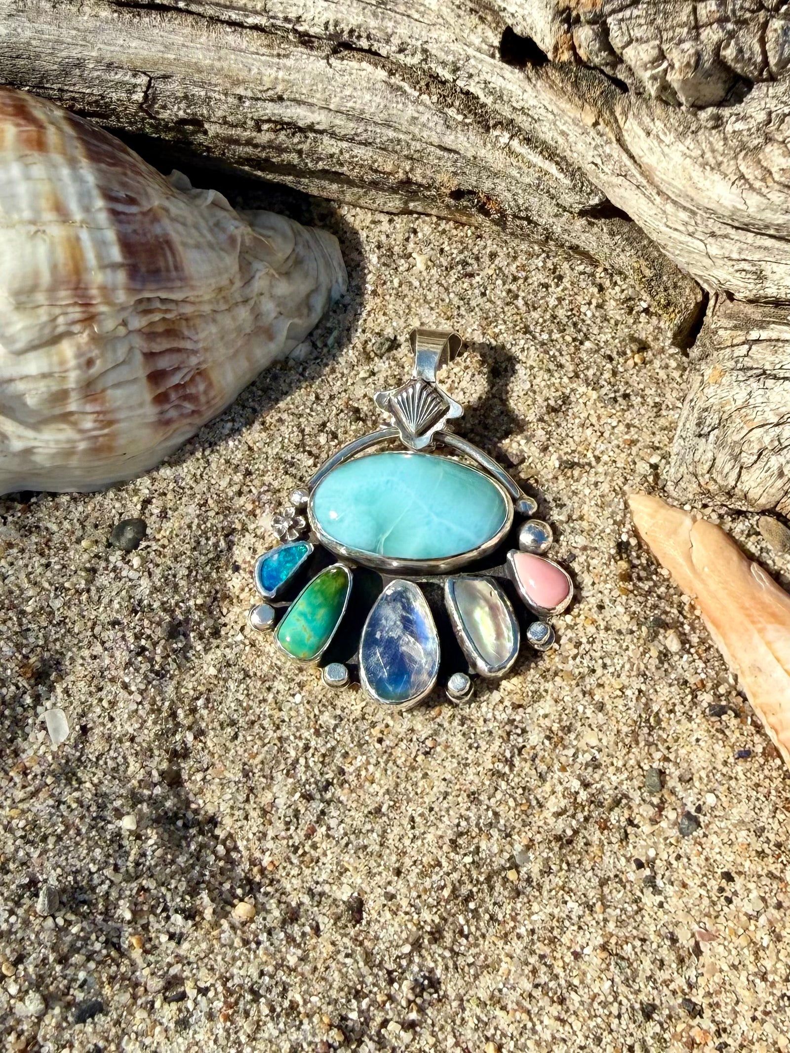 Close-up of Larimar stone and rainbow moonstone showing blue color and rainbow flash