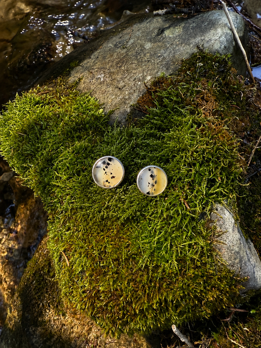 Handmade round Montana Agate sterling silver stud earrings featuring natural translucent coloring and distinctive dark inclusions.