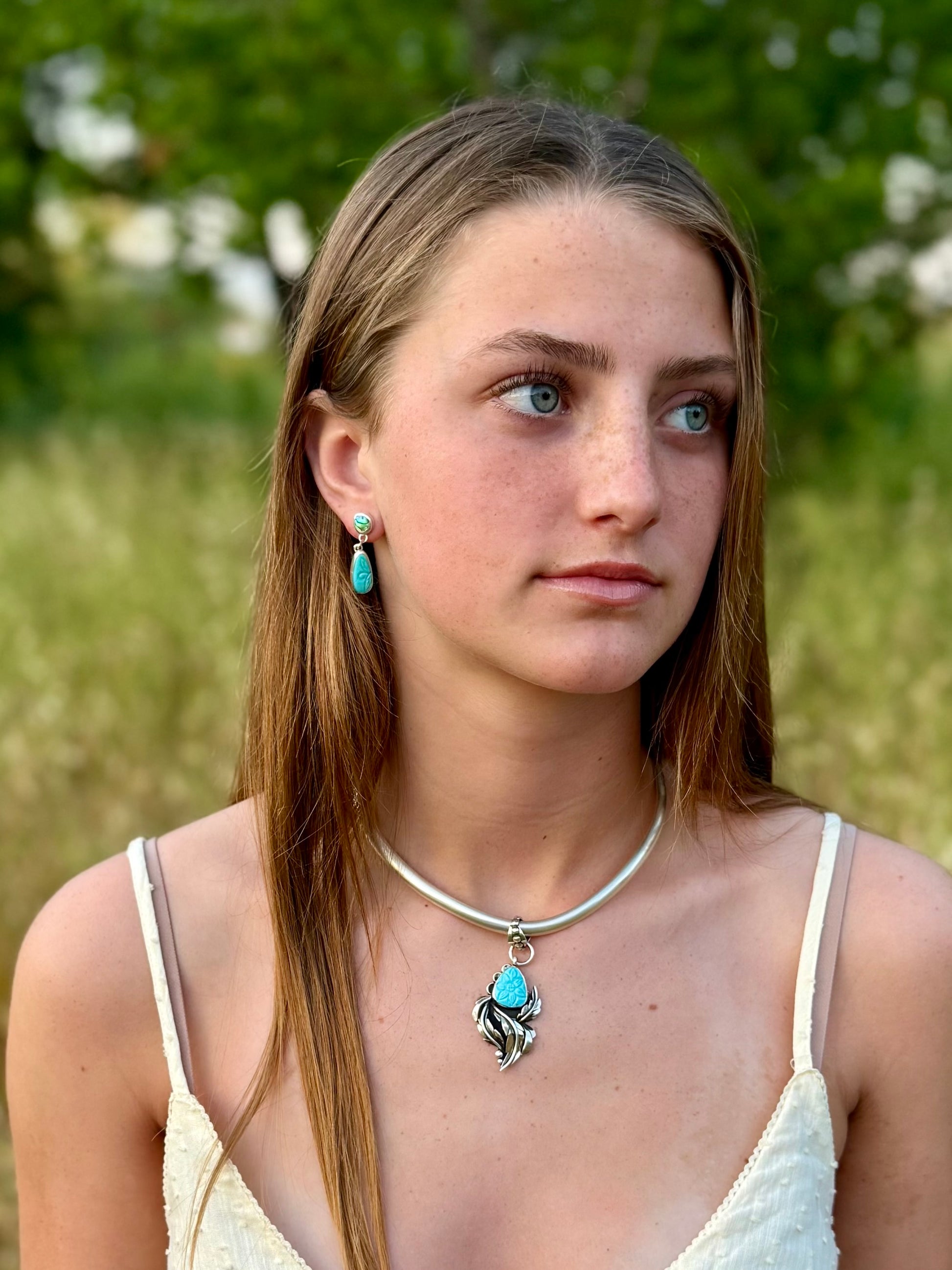 Hand carved floral Persian turquoise pendant worn, boho western style jewelry
