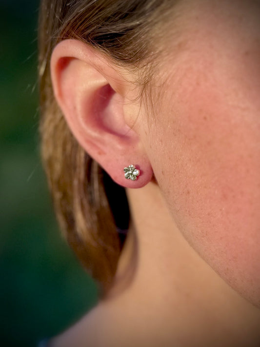 Sterling silver flower stud earrings worn, minimalist everyday floral jewelry