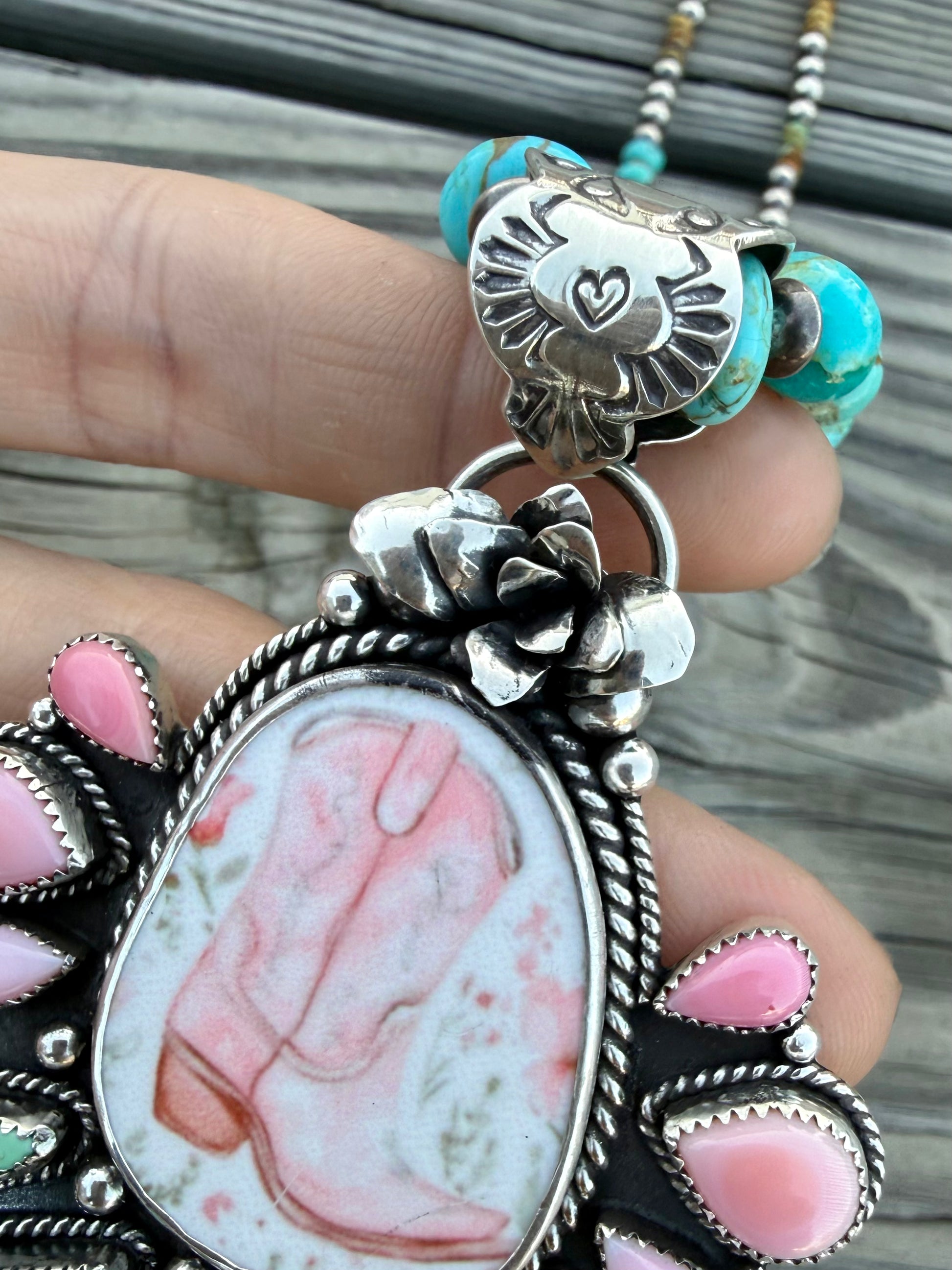 Handmade porcelain cowboy boot pendant with Royston turquoise, pink conch, and sterling silver succulent detail up close