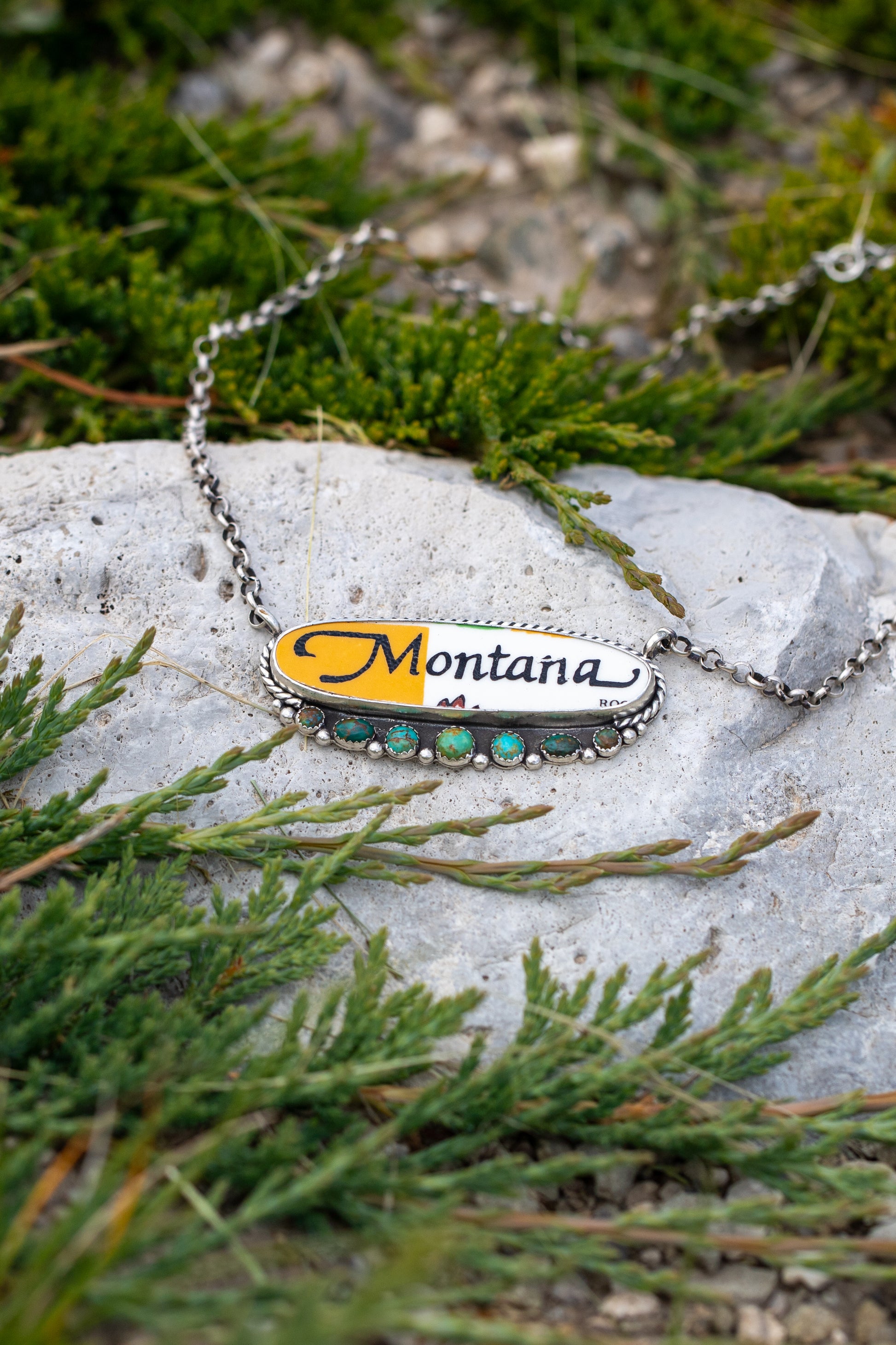 Handmade sterling silver Montana necklace featuring a porcelain Montana cabochon accented with genuine Kingman Turquoise on an 18-inch chain with a 1-inch extender.