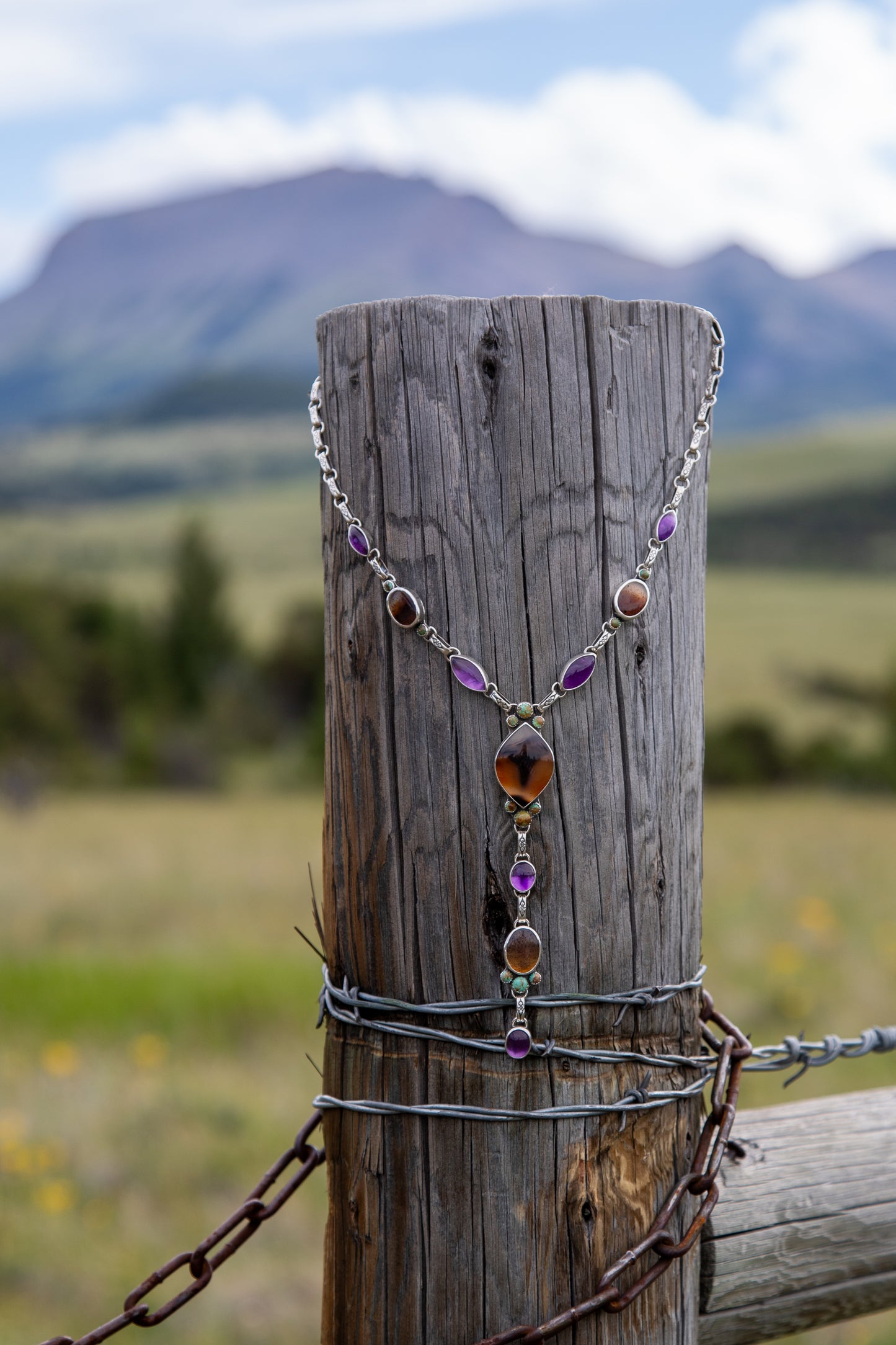 Handmade sterling silver lariat necklace featuring Montana Agate, Kingman Turquoise, and Amethyst with a handcrafted link-by-link chain and elegant five-inch drop.