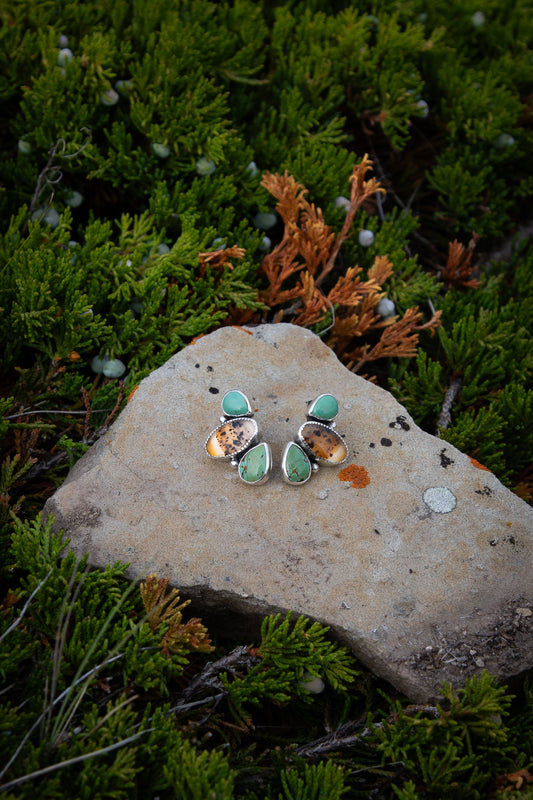 Handmade sterling silver post earrings featuring genuine Montana Agate and Kingman Turquoise gemstones in a modern three-stone design with a high polish finish.