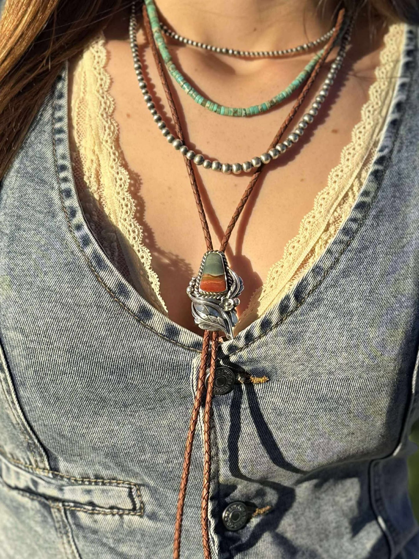 Full bolo tie showing braided cord, stone setting, and silver tips