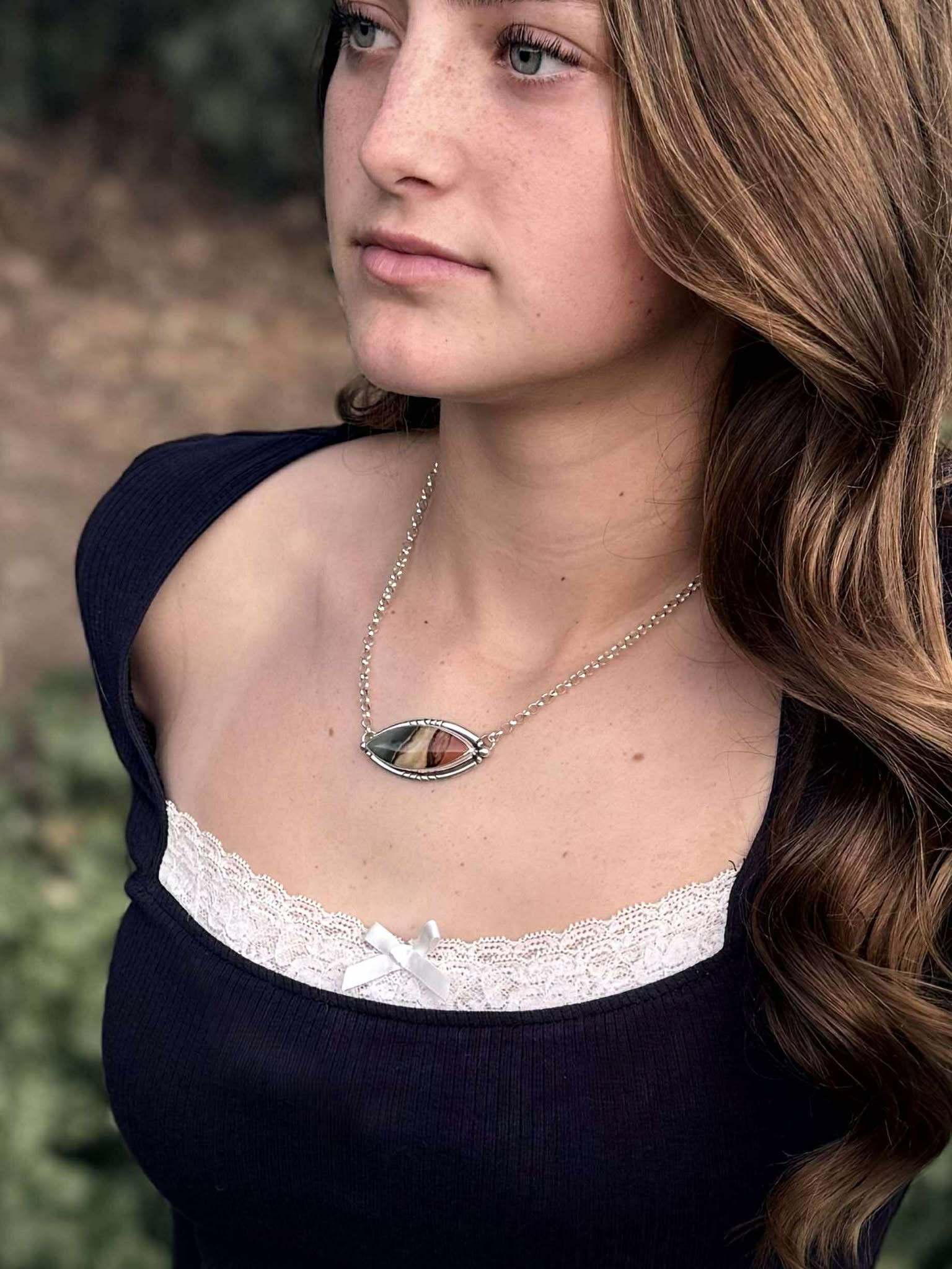 Side view of sterling silver bar necklace showing stone setting and profile