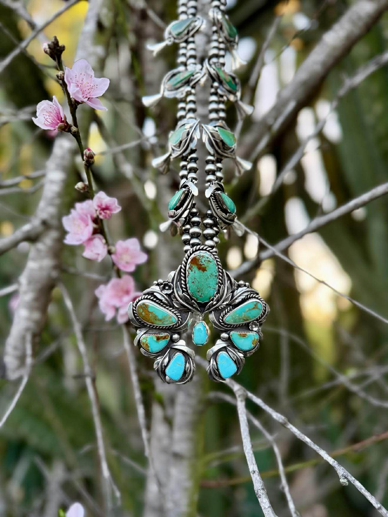Turquoise Naja centerpiece of squash blossom necklace showing sterling silver detail and stone arrangement