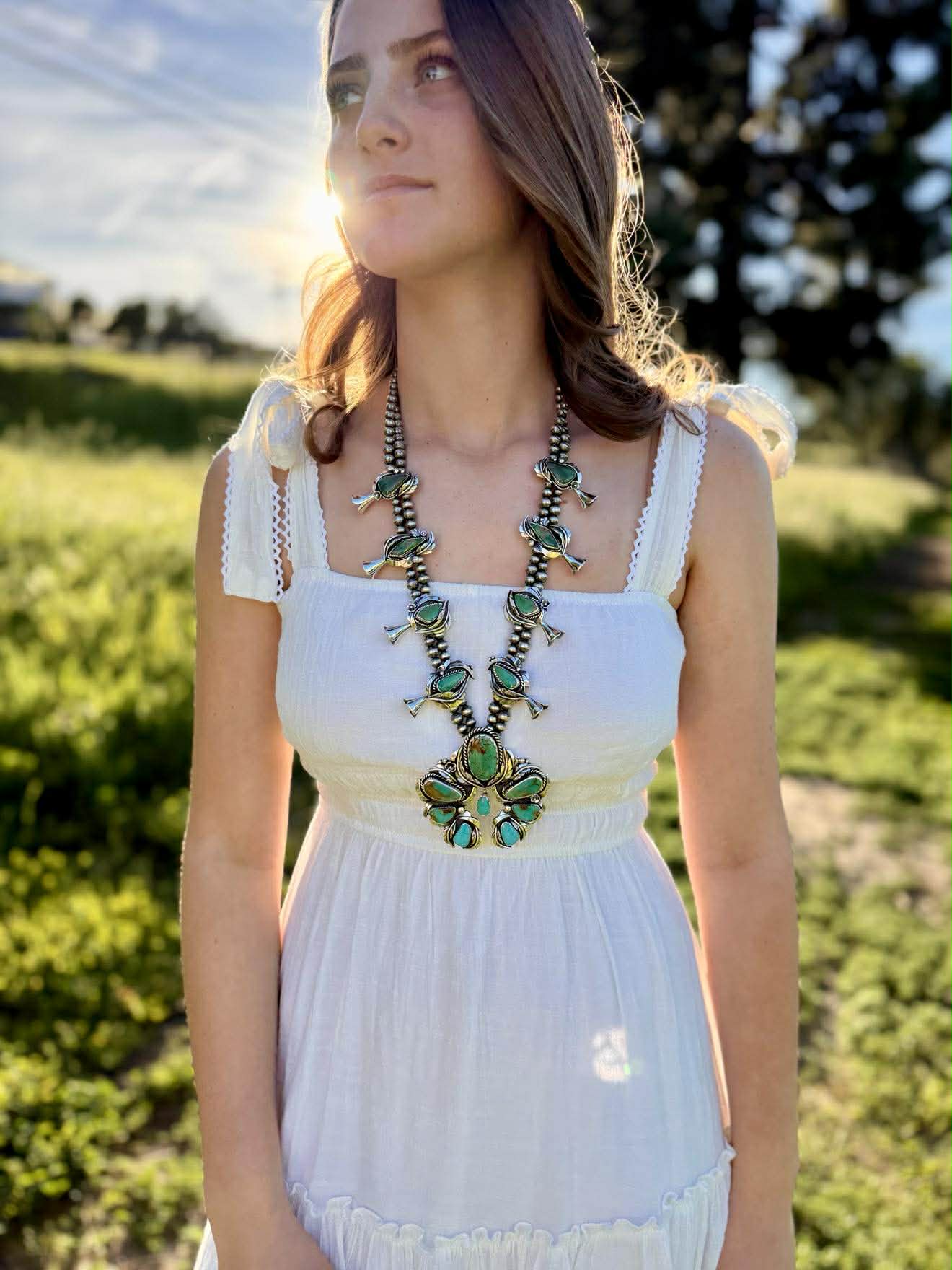 Ombre Turquoise Naja centerpiece of squash blossom necklace showing sterling silver detail and stone arrangement