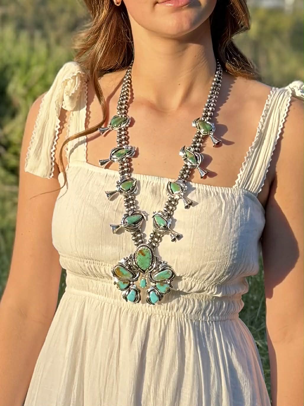 Large Ombre turquoise squash blossom necklace showing size and proportions when worn