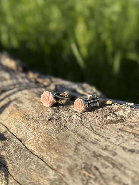 Close-up of pink conch showing smooth natural pink color with rose and leaf detail